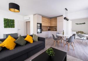a living room and kitchen with a couch and a table at Quality apartman in Tihany