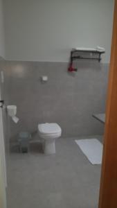 a bathroom with a white toilet in a room at Coliving Bem Estar in Bauru +17 photos
