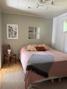 a bedroom with a bed and a table and a window at Solmula in Keuruu