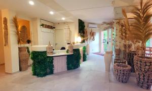 a large kitchen with green walls and a counter at Hotel Tennis International in Cap d'Agde