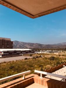 a view of a building with mountains in the background at Apartamento acogedor Torremar Marina Dor in Oropesa del Mar +15 photos