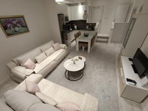 a living room with a white couch and a table at Lux Old Bridge in Mostar