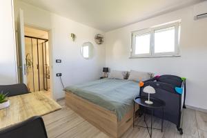 a bedroom with a bed and a table in it at LaraBella Salt fields view studio in Portorož