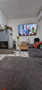 a living room with a couch and a flat screen tv at Kuća za odmor Jožić in Novakovec
