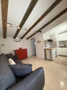 a living room with a couch and a kitchen at Camping Armalygal in Murillo de Gállego