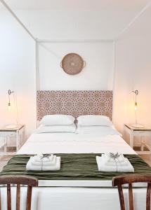 a bedroom with a large bed with two towels on it at Trullo San Vincenzo con Piscina in Monopoli