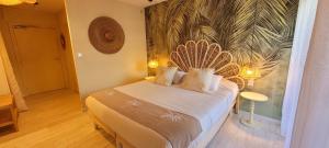 a bedroom with a bed with a large mural on the wall at Hotel Tennis International in Cap d'Agde +74 photos