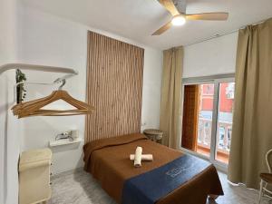 a room with a bed with a cross on it at Habitación en Calle Molino in Málaga