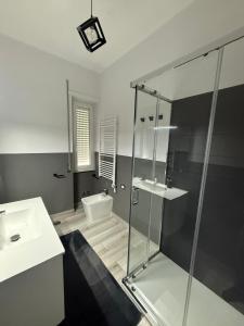 a bathroom with a glass shower and a sink at Casa Flavia in Bracciano