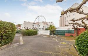 a parking lot with a ferris wheel in the background at Studio La perle clim balcon parking privé in Cap d'Agde