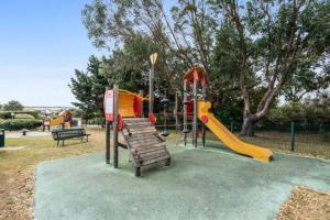 a park with a playground with a slide at Appartement Arzon 4 - 5 PERSONNES , tout à pied, mer - port du crouesty - piscine in Arzon