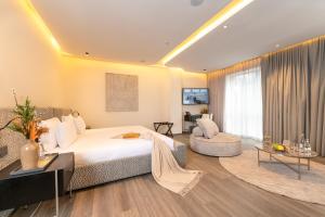 a bedroom with a bed and a couch and a table at Suites By Le Rêve in Tangier +114 photos