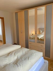 a bedroom with two beds and a large wooden cabinet at Ferienwohnung Ana in Langenlois