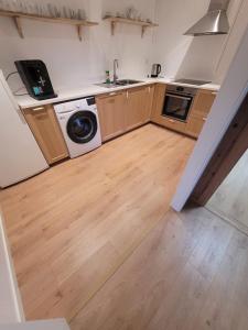 a kitchen with a sink and a washing machine at Adventure house Katrine in Mosvik