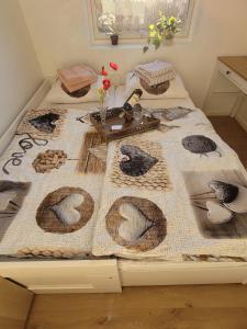 two beds with a blanket with birds on it at Adventure house Katrine in Mosvik +6 photos
