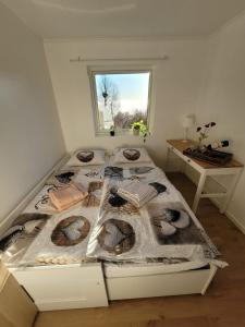 a bed in a room with a window at Adventure house Katrine in Mosvik