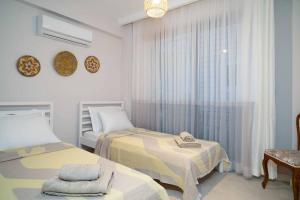 a bedroom with two beds and a window at Mama Saggio Home in Fethiye