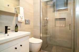 a bathroom with a shower and a toilet and a sink at Mama Saggio Home in Fethiye +8 photos
