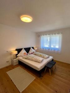 a bedroom with a large bed and a window at Neue Fewo Mosel-Glück - Urlaub im Wein- und Ferienort Bekond - Direkte Autobahnanbindung nach Trier & Luxembourg in Bekond