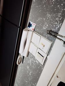 a door with a refrigerator and a bunch of receipts at The Roberstson family suite with city views in Kuala Lumpur