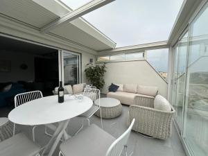 a patio with a table and chairs and a couch at Blanch Holiday Apartments in St Paul's Bay