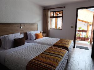 Postel nebo postele na pokoji v ubytování Casona Tobar Hotel