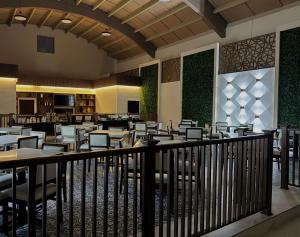 a dining room with tables and chairs in a restaurant at Hangar Inn TJ - Aeropuerto in Tijuana