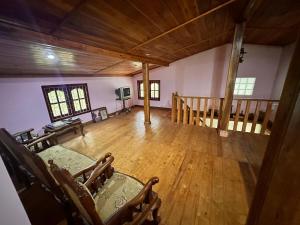 an empty living room with wooden floors and a wooden ceiling at Pears Villa Resort Haputale in Ginigatgala