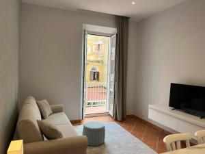 a living room with a couch and a television at L'Aurora Casa Vacanze in Anzio