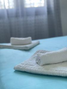 two towels sitting on top of a blue counter at Plaka Luxury Villa in Litochoro +55 photos