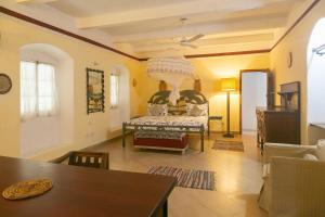 a living room with a chair and a table at Zanzibar Vintage House in Stone Town