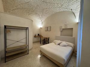 una camera da letto con un letto e un tavolo in una stanza di Volta Meraviglia a Martina Franca Altre 9 foto