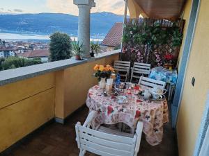 a table on a balcony with a table and chairs at Villa Kira 2 in Verbania