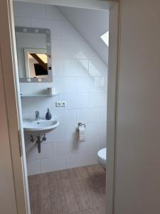 a bathroom with a sink and a toilet at Pension Hesse in Lüdenscheid +20 photos
