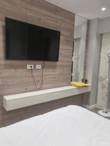 a bedroom with a flat screen tv on a wall at Kodra e diellit residence 2 in Selitë e Vogël +7 photos