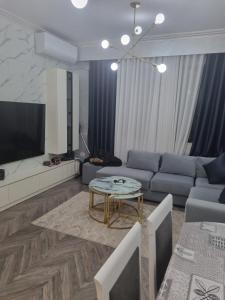 a living room with a couch and a table at Kodra e diellit residence 2 in Selitë e Vogël