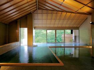 an empty room with a pool in the middle of it at Ookawaso in Aizuwakamatsu