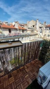 a wooden deck with a fence and buildings at Apartment in Noailles Marseille in Marseille