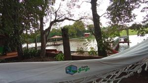 a tent is set up in front of a body of water at Chalet del lago Don Asterio in Ciudad del Este
