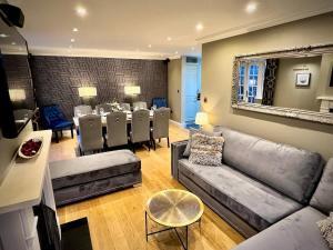 a living room with a couch and a dining room at Honey Hill Cottage - 4 Bedroom Detached House in Cambridge