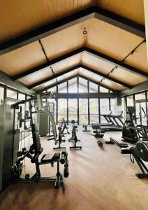 a gym with several treadmills and machines in a room at Amani 311 Suites - Double bed with Single Pull Out Bed in Pusok