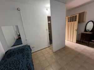 a bedroom with a mirror and a bed in a room at Monoambiente NONA in Villa Cura Brochero