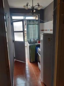 a kitchen with a refrigerator and a table in it at Monoambiente NONA in Villa Cura Brochero