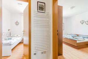 a room with a bed and a door with a mirror at Apartma Mama Bovec in Bovec