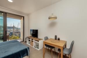 a bedroom with a bed and a table and a window at Mare in Meljine