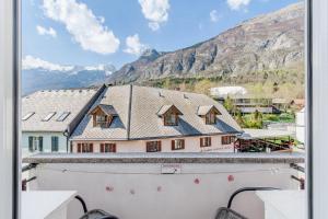 a view from the balcony of a house with mountains in the background at Apartma Mama Bovec in Bovec