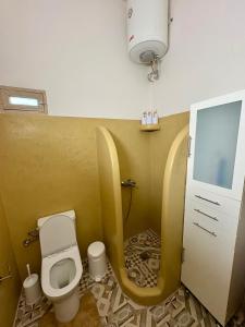 a small bathroom with a toilet and a sink at Caserma Regina in Gourna +8 photos
