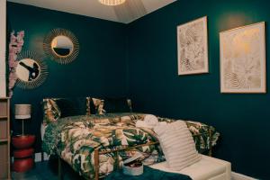 a bedroom with a bed with blue walls and mirrors at Firdaus Westgate 5 in Huddersfield
