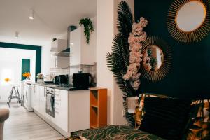 a living room with a couch and a kitchen at Firdaus Westgate 5 in Huddersfield