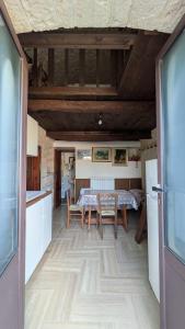 a kitchen and dining room with a table and chairs at Trullo Malvisco in Alberobello +13 photos